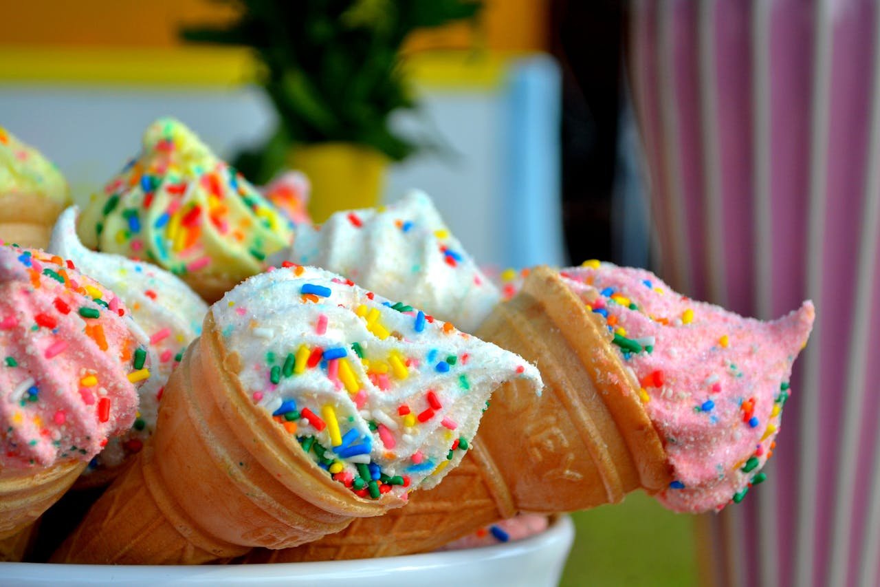 about-03 Vibrant ice cream cones topped with colorful sprinkles, perfect for summer treats.